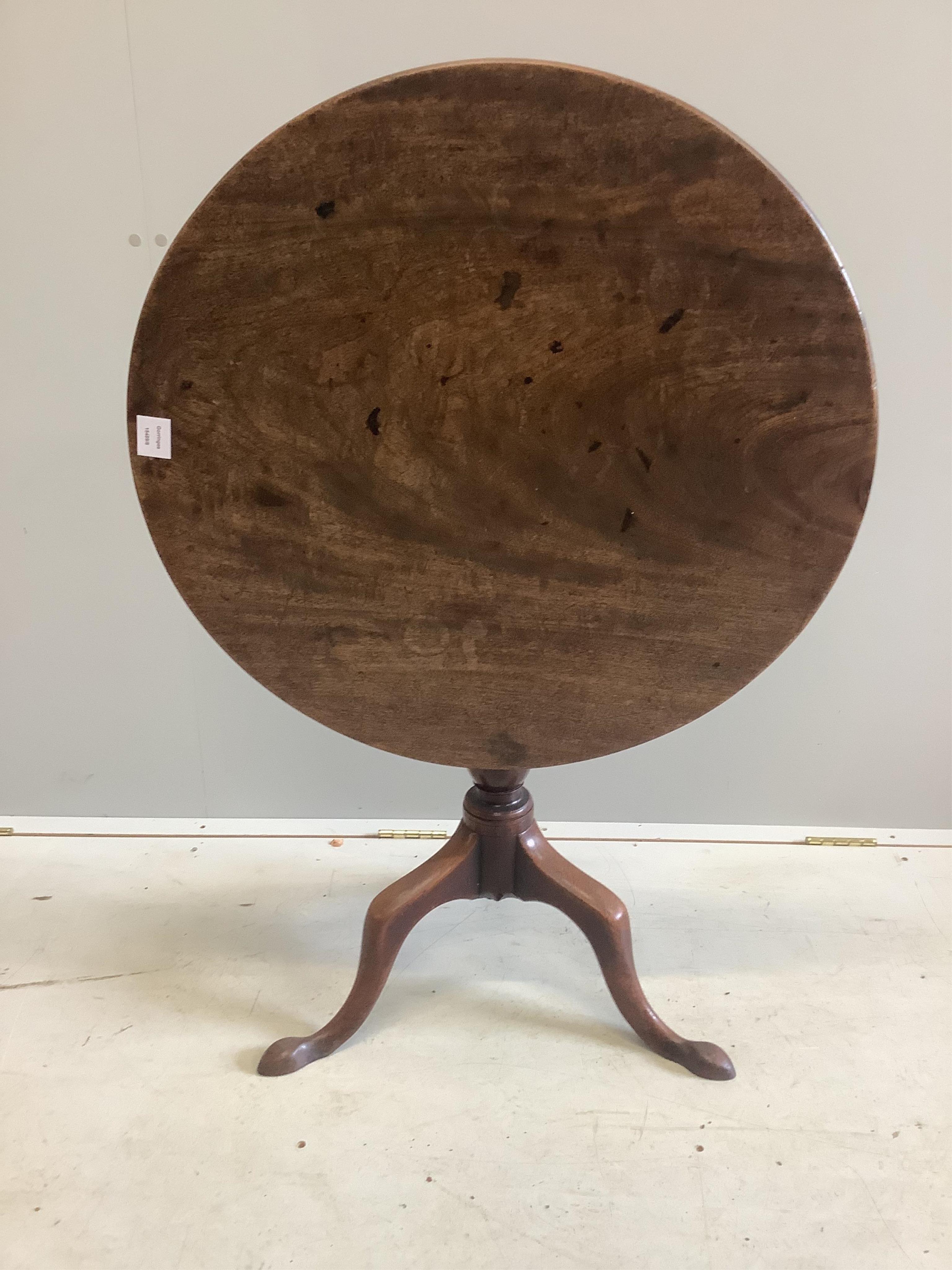 A George III circular mahogany tilt top tea table, diameter 73cm, height 70cm. Condition - fair